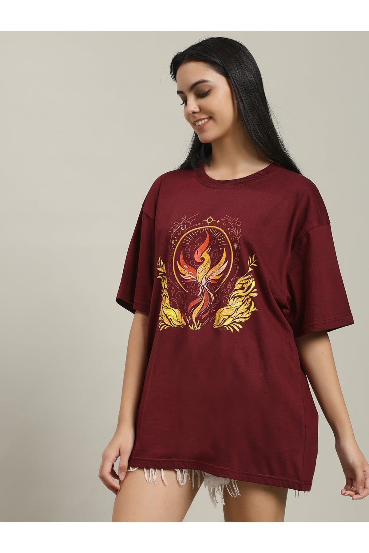 Front view of a woman wearing a plain maroon Fire women's over-sized T-shirt, showcasing its relaxed fit and simple crew neckline